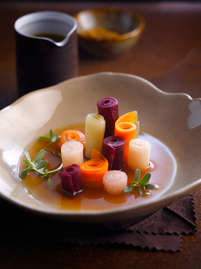 Broth with rolled vegetable strips