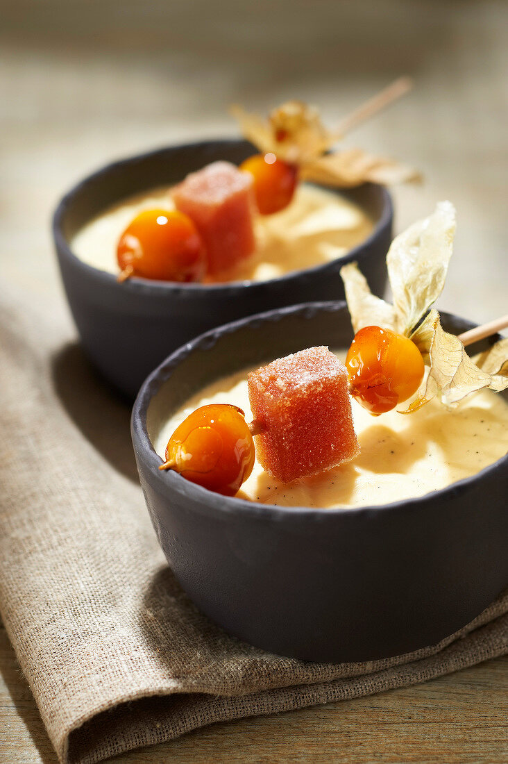 Vanilla custard with apples roasted with ginger,fruit paste and caramelized physalis brochette