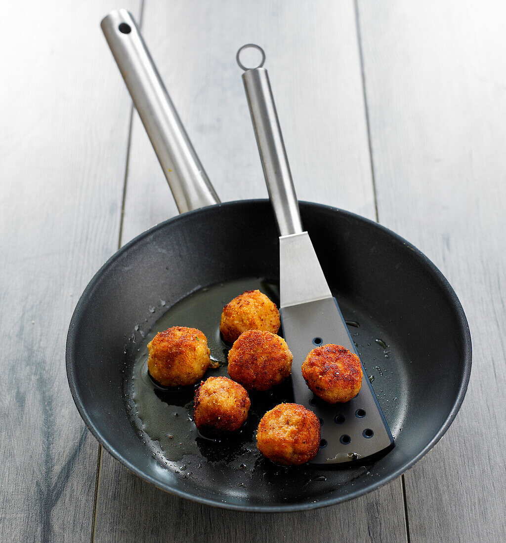 Pan-frying the veal croquettes