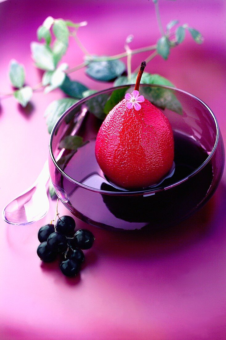 Poached pear in blackcurrant syrup