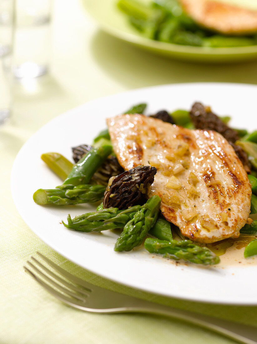 Veal Piccata with green asparagus and morels