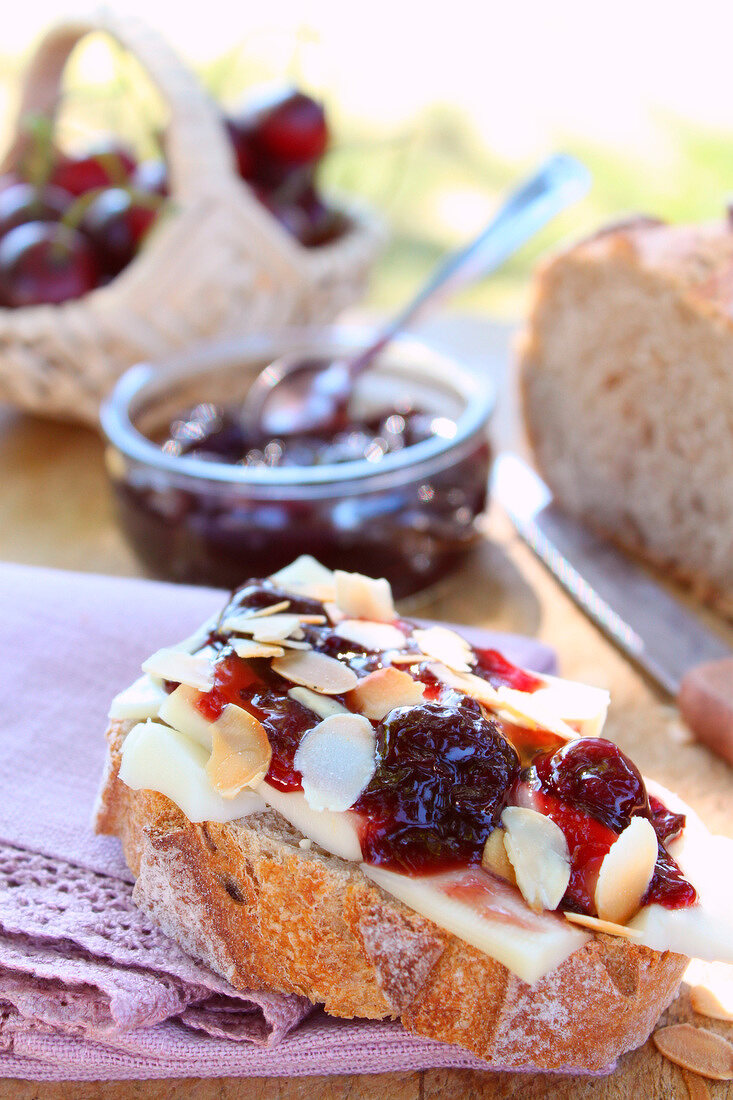 Sheep's milk cheese,black cherry jam and thinly sliced almond open sandwich