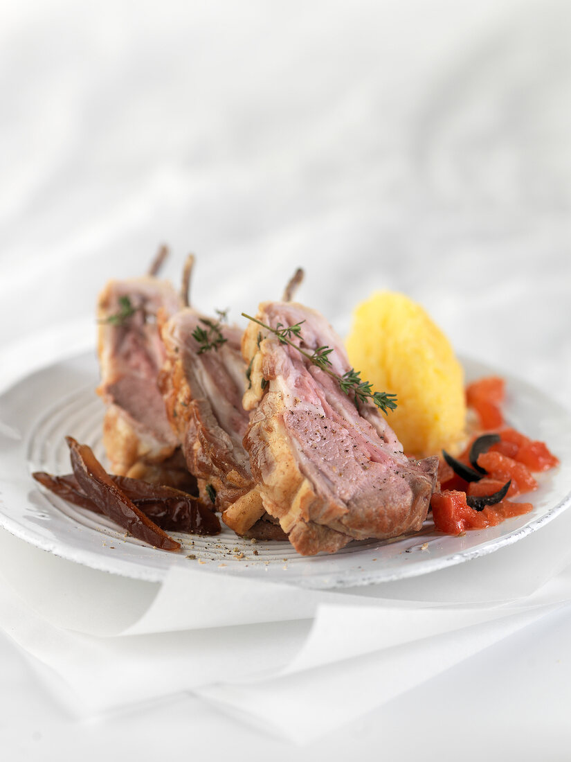 Roasted loin of lamb with rosemary in flower, potatoes with tomato flash and dates