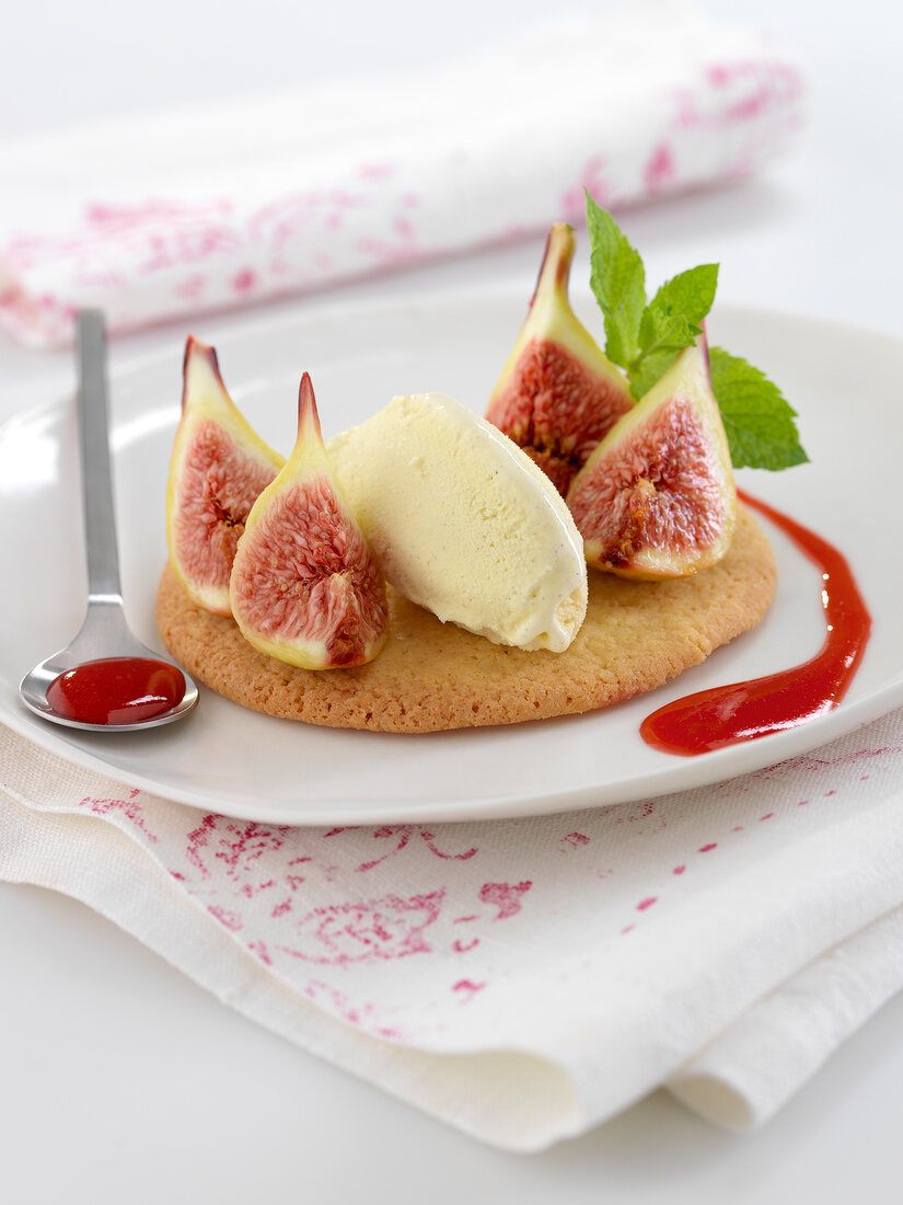 Breton shortbread cookie topped with figs, vanilla ice cream and raspberry puree