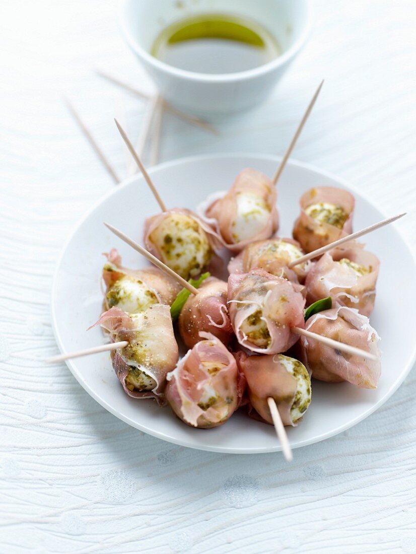 Small mozzarella balls with crushed pistachios and wrapped in Aoste ham