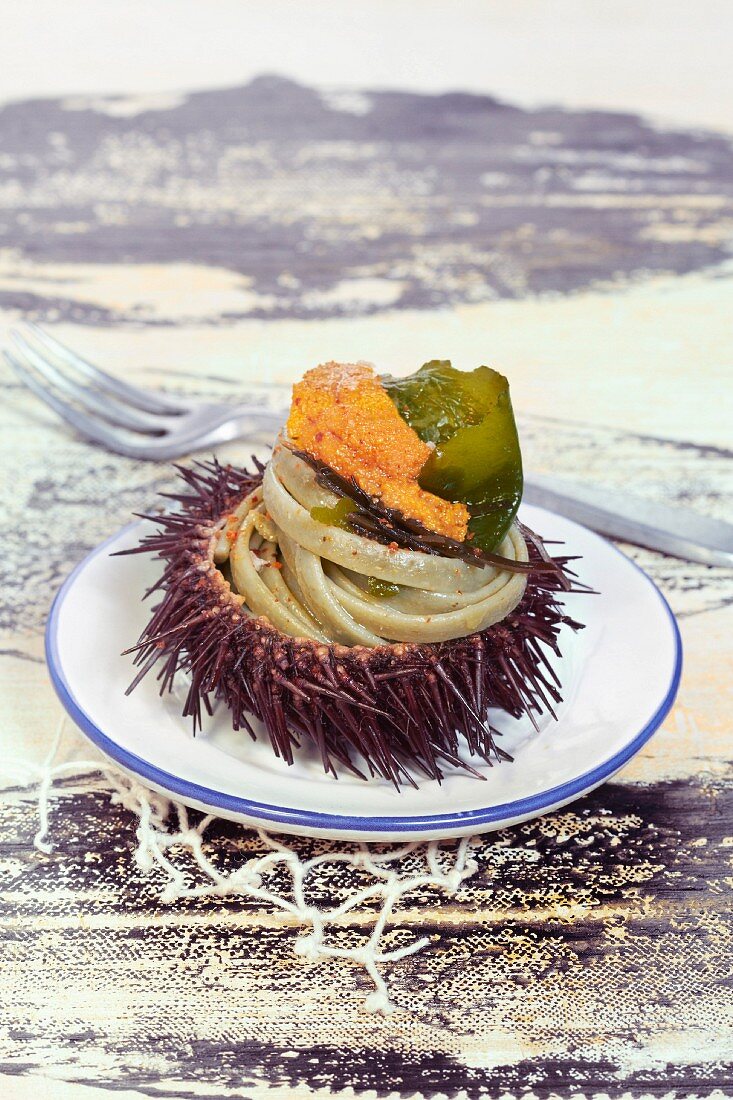 Pasta with urchin roe and seaweed served in an urchin
