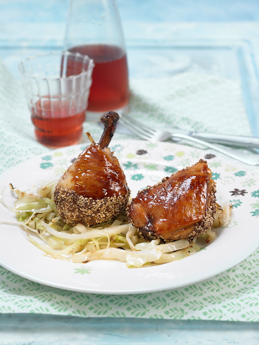 Chicken glazed in honey with black and golden sesame seeds, braised cabbage