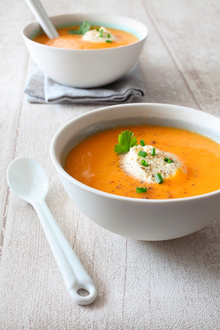 Cream of carrot and coconut milk soup with coriander and ginger