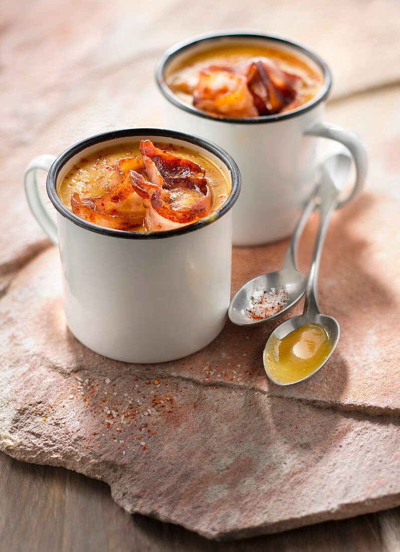 Cream of orange lentil soup with crisp streaky bacon
