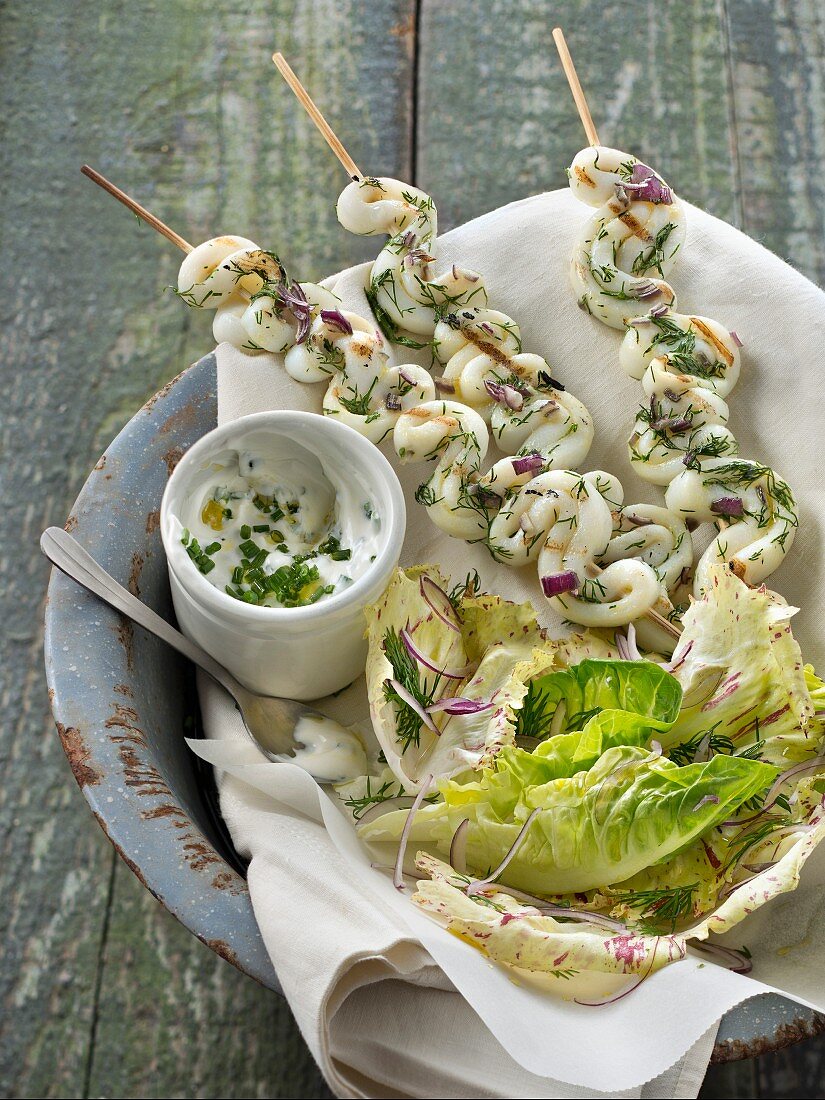 Grilled squid and dill brochettes, chive cream and crisp lettuce salad