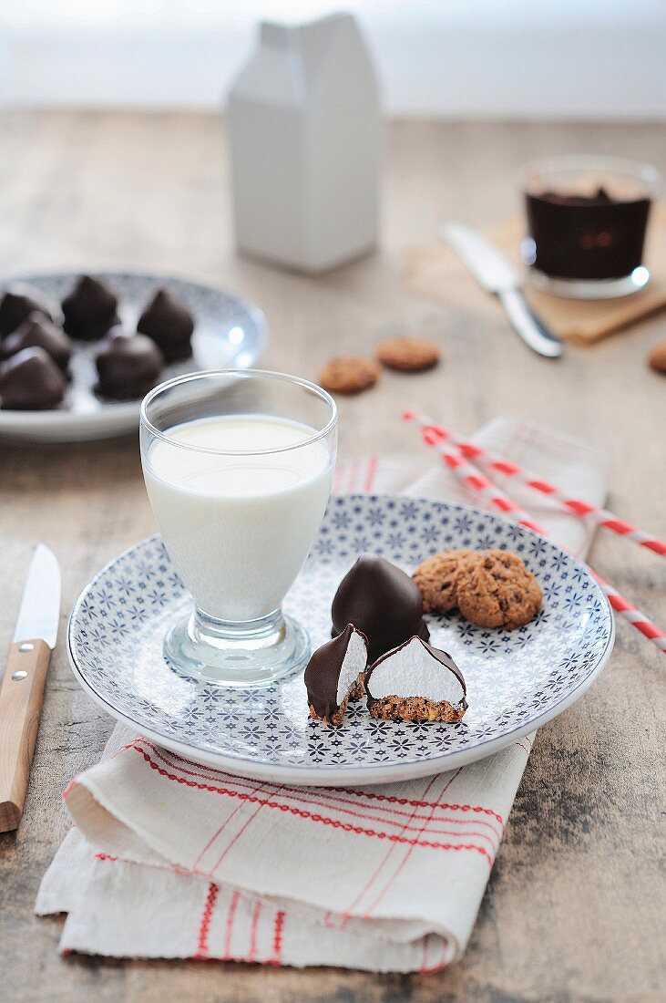 Chocolate and meringue drops and a glass of milk