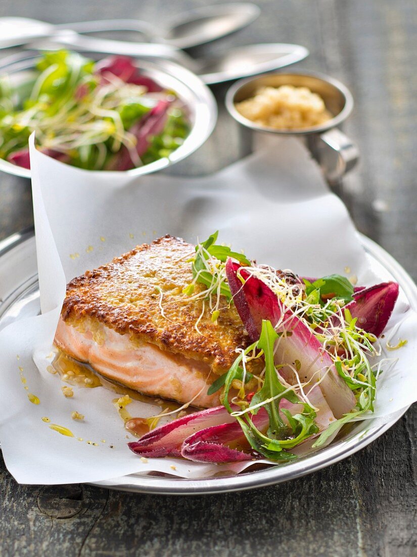 Salmon steak in quinoa crust,red chicory and rocket lettuce salad