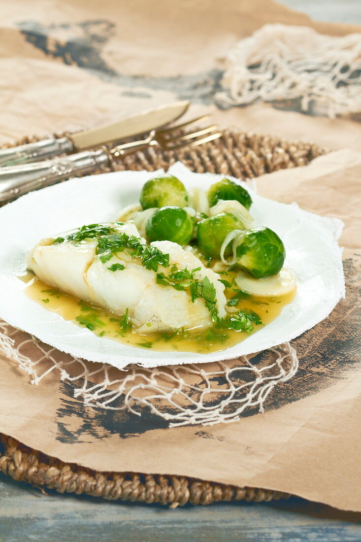 Cod with herb butter, pan-fried Brussel sprouts and leeks