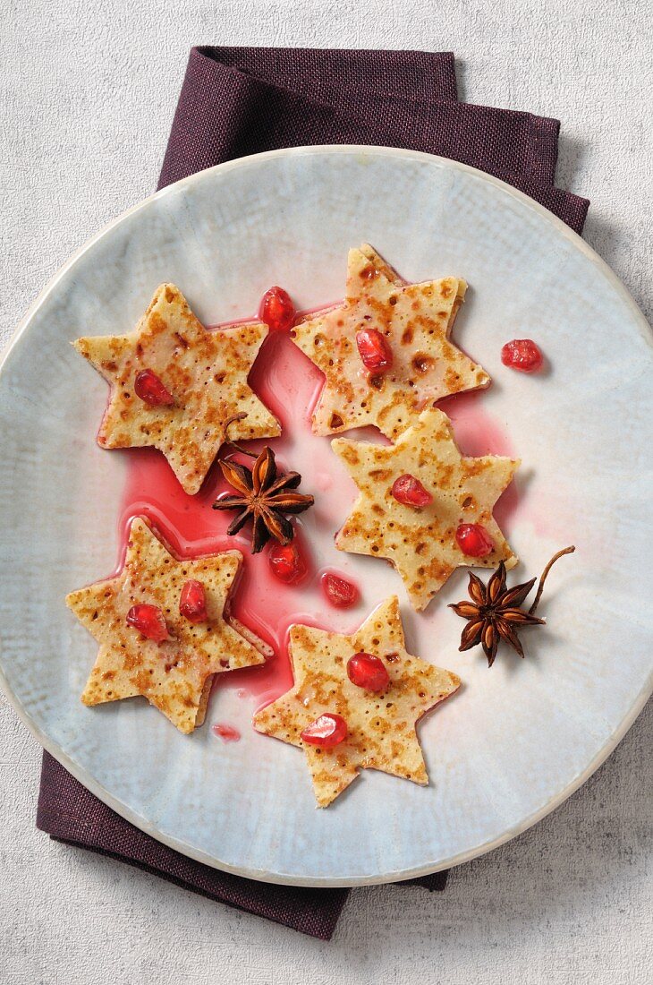 Star-shaped pancakes with honey and pomegrante seeds