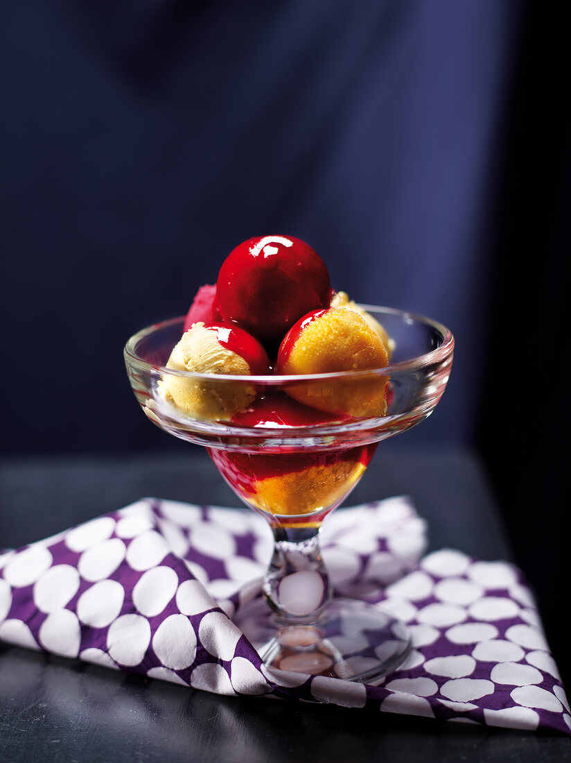 Dish of ice-cream with summer fruit coulis