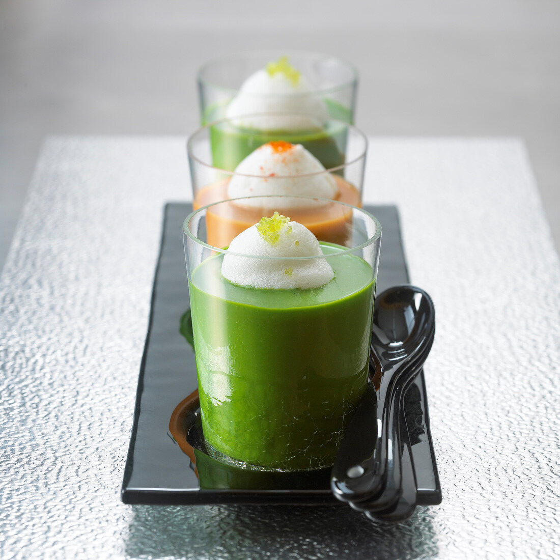 Glasses of watercress soup and glass of lobster bisque