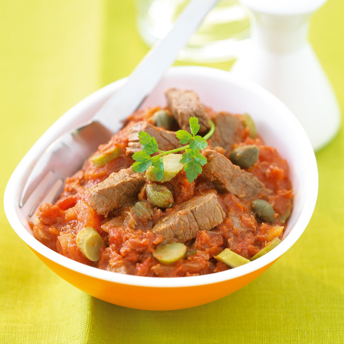 Beef with stewed tomatoes, capers and chopped gherkins