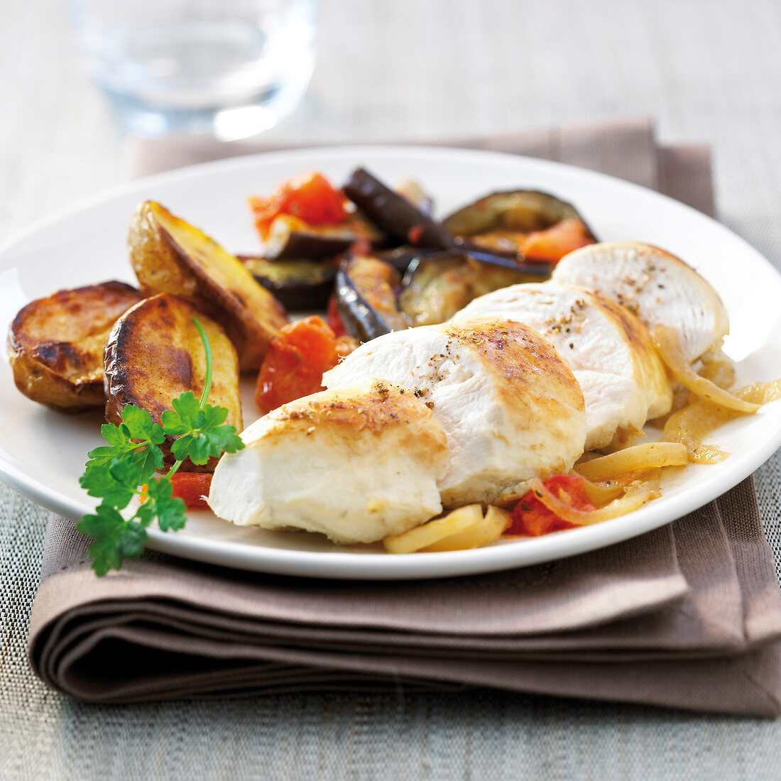 Chicken breast with onions,pan-fried eggplants and oven-roasted potatoes