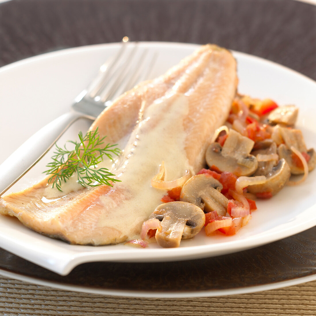Fillet of trout with creamy sauce,mushrooms,tomatoes and onions