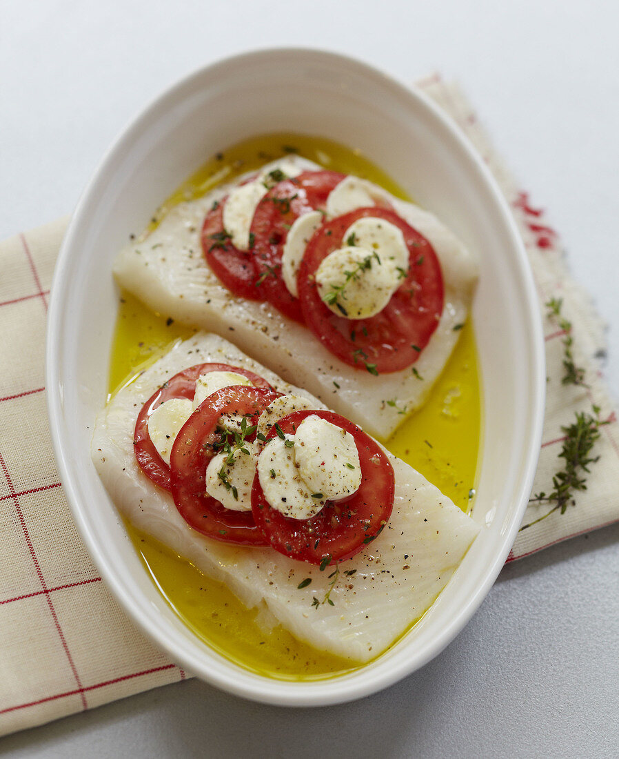 Preparing the halibut with toamtoes and mozzarella