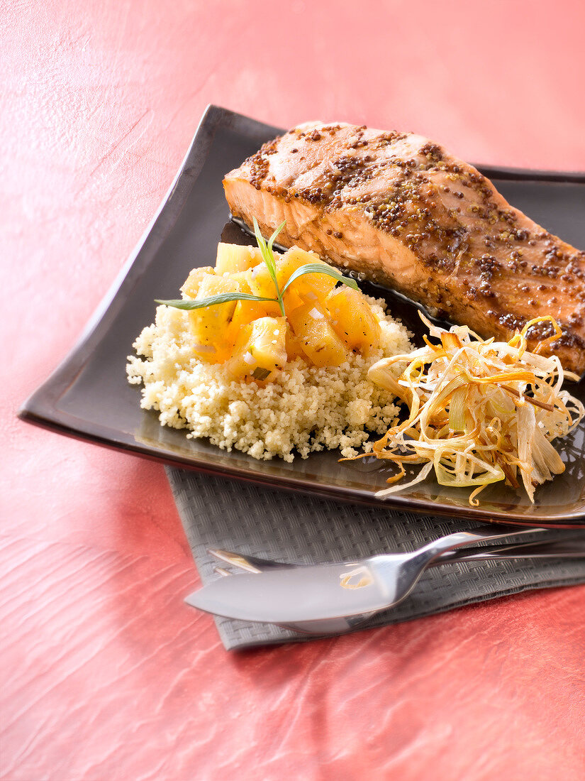 Piece of salmon in honey and mustard seed crust, pineapple and tarragon semolina