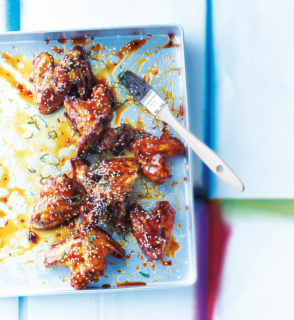 Chicken wings in cola sauce and sesame seeds