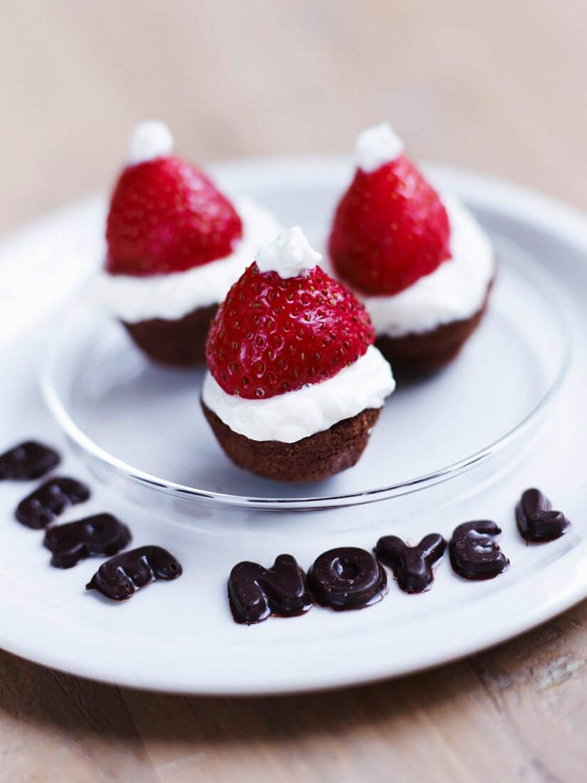 Pere Noel writter in chocolate letters and chocolate fondant,strawberry and whipped cream bites
