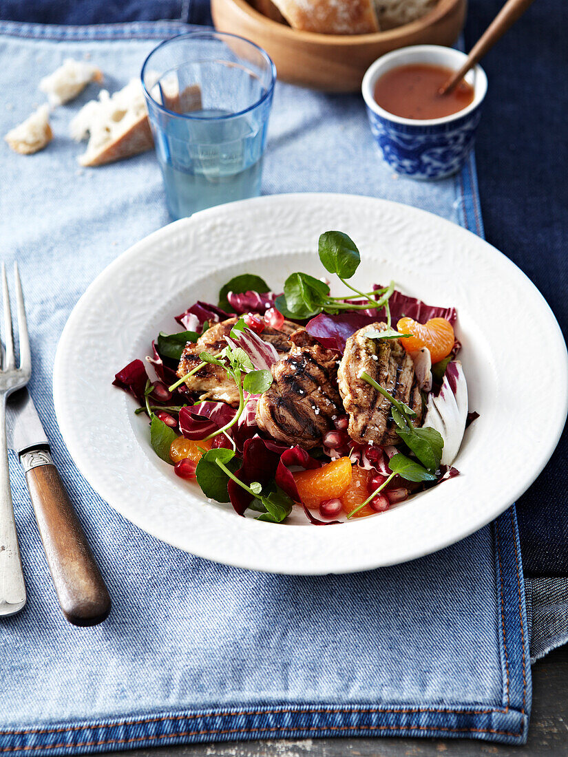 Clementine and pomegranate red and green salad with grilled lamb chops