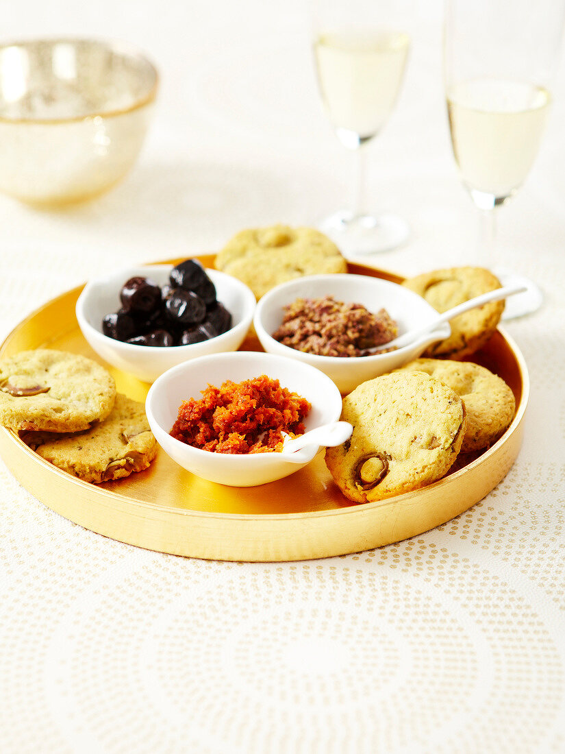 Savoury olive cookies,chopped confit tomatoes and green olive paste