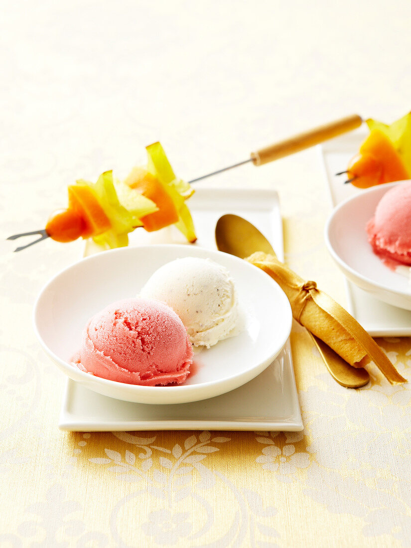 Plate of guava and vanilla ice cream with exotic fruit brochettes