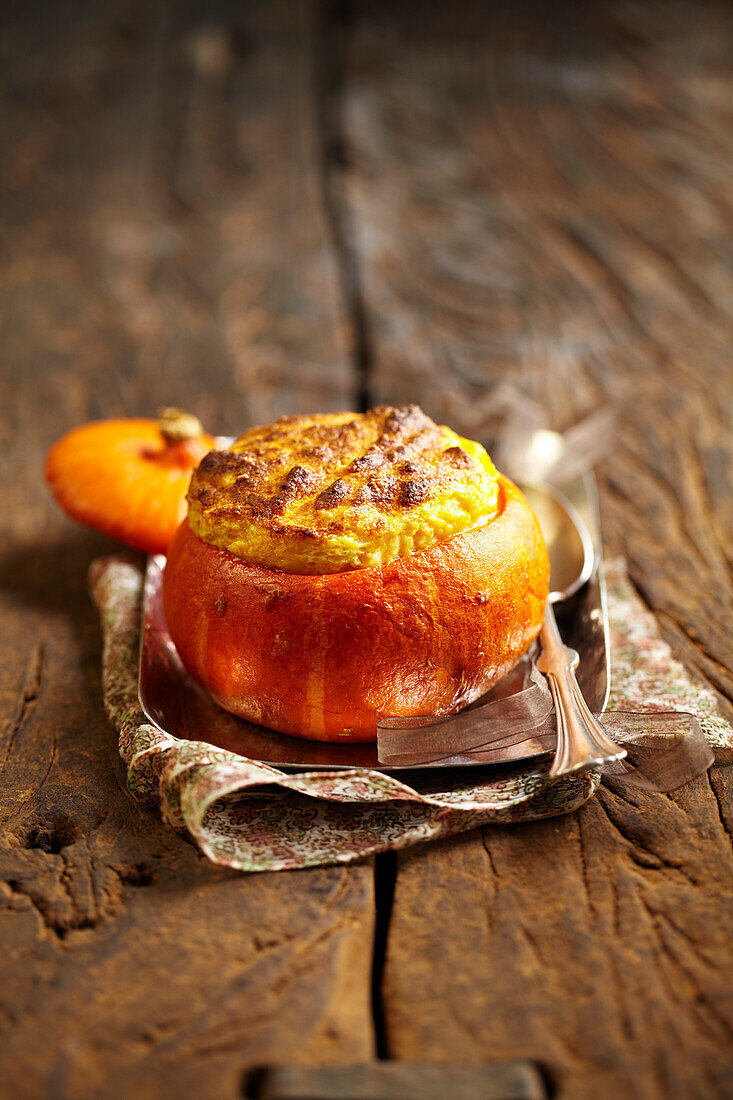 Pumpkin soufflé served in a pumpkin skin