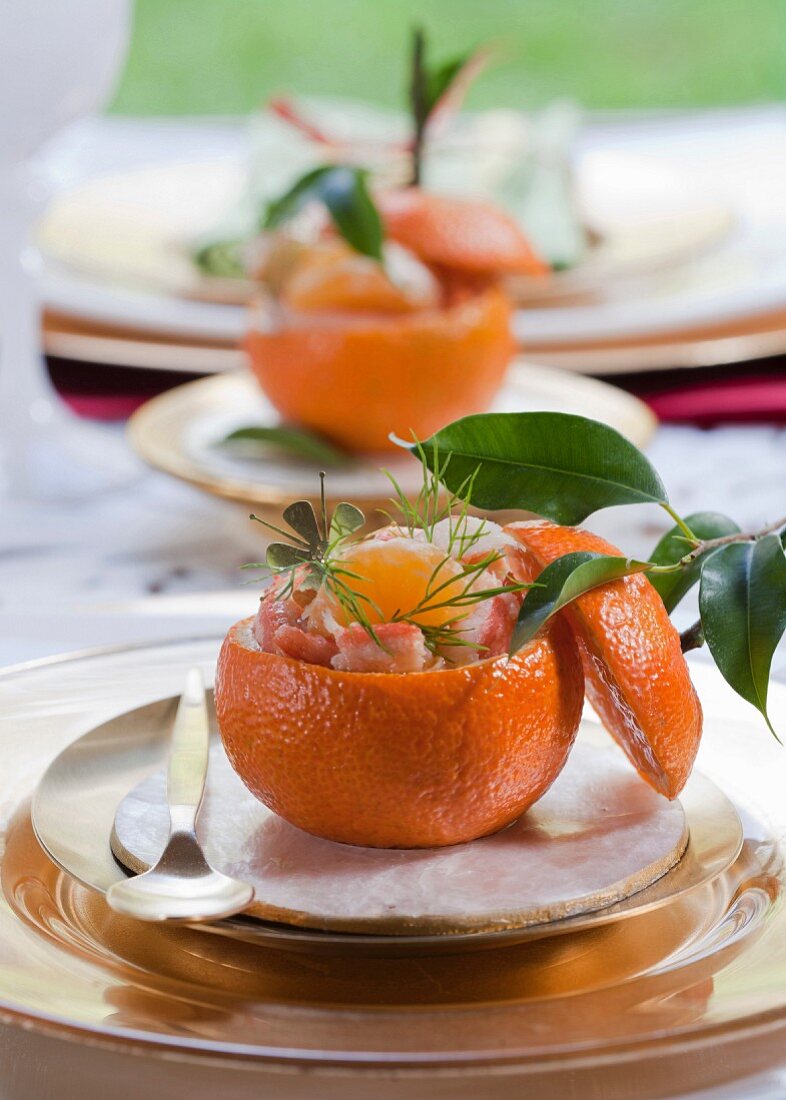 Surimi, shrimp and clementine salad served in a clementine