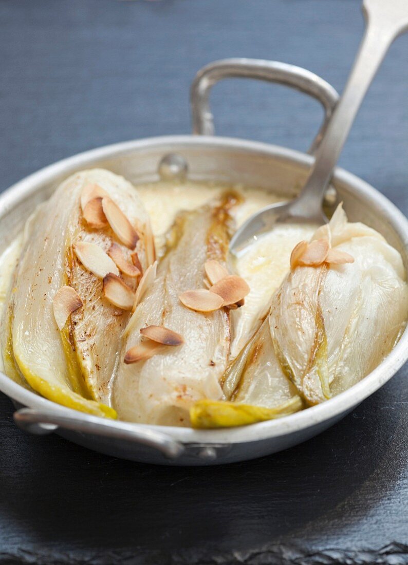 Braised chicory with cream and thinly sliced almonds