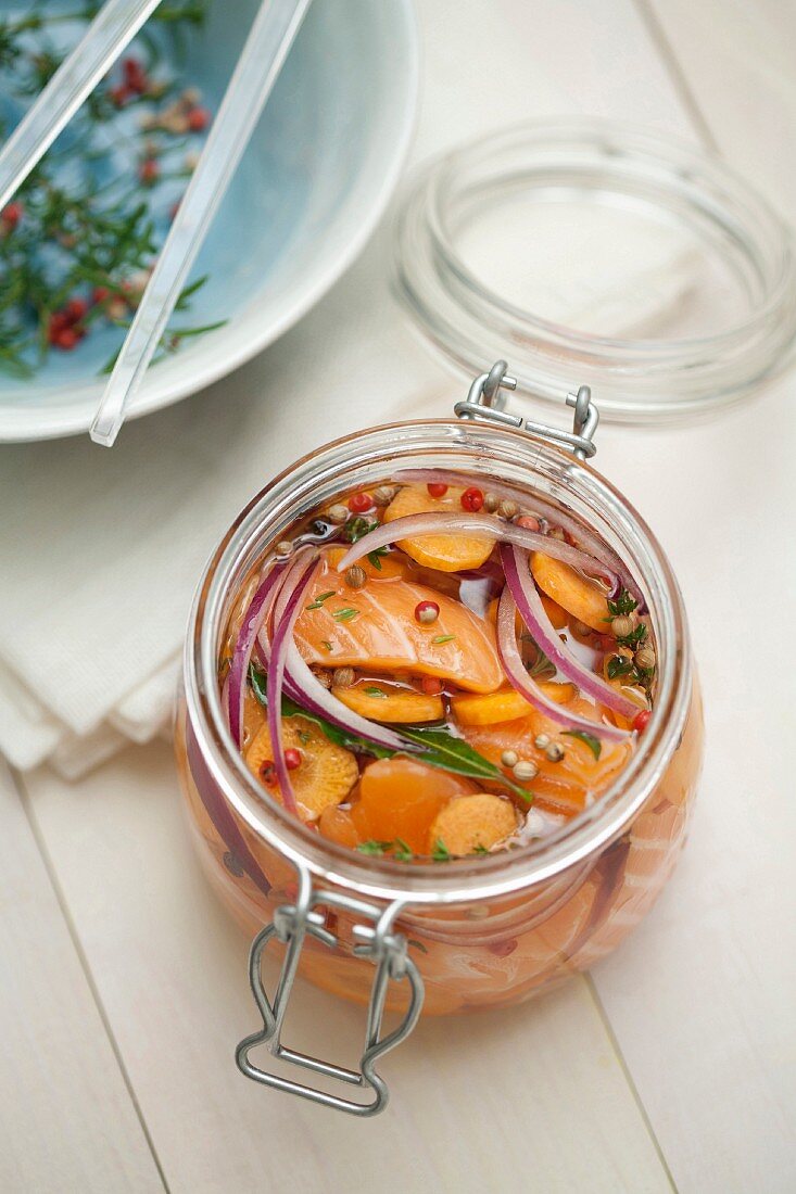 Jar of marinated salmon with seasonings