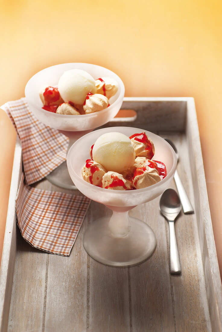 Vanilla ice cream, small french meringue and strawberry puree sundaes