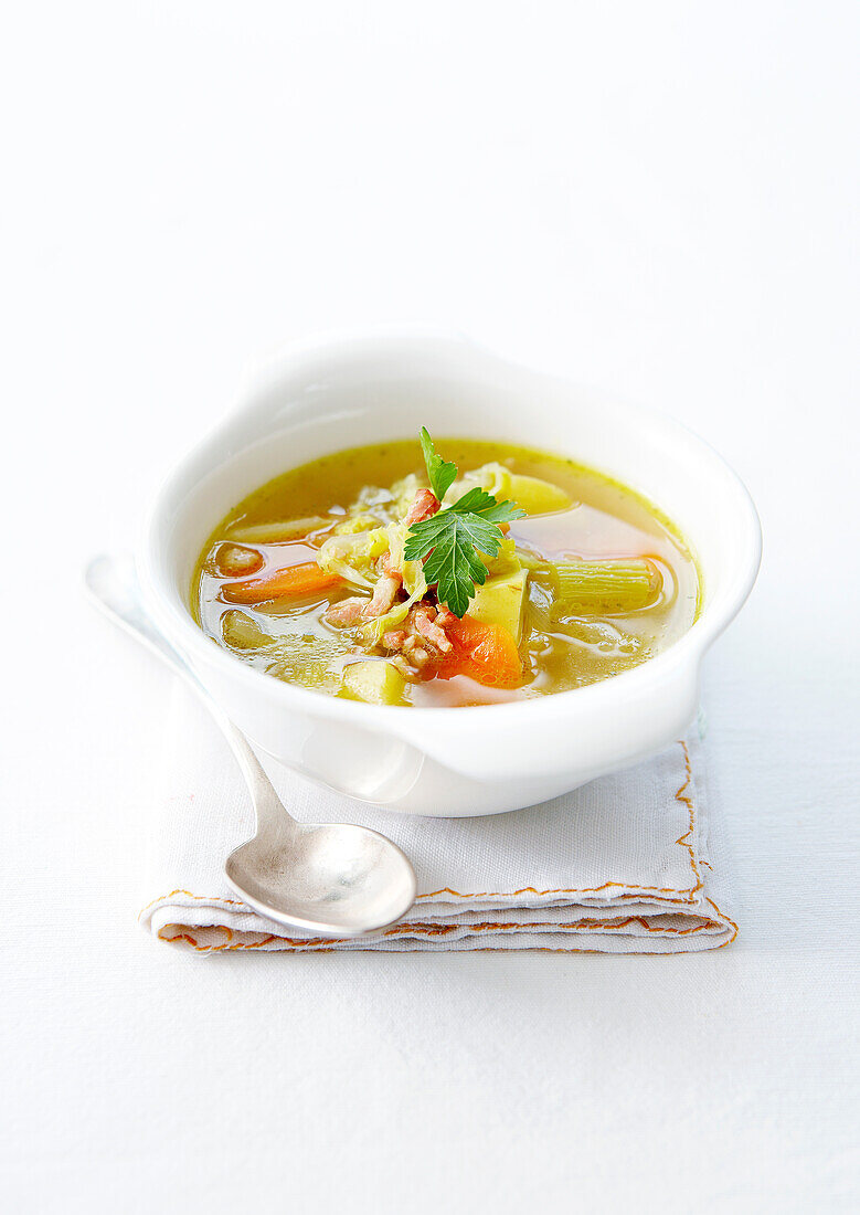 Vegetables broth with olive oil and lardons