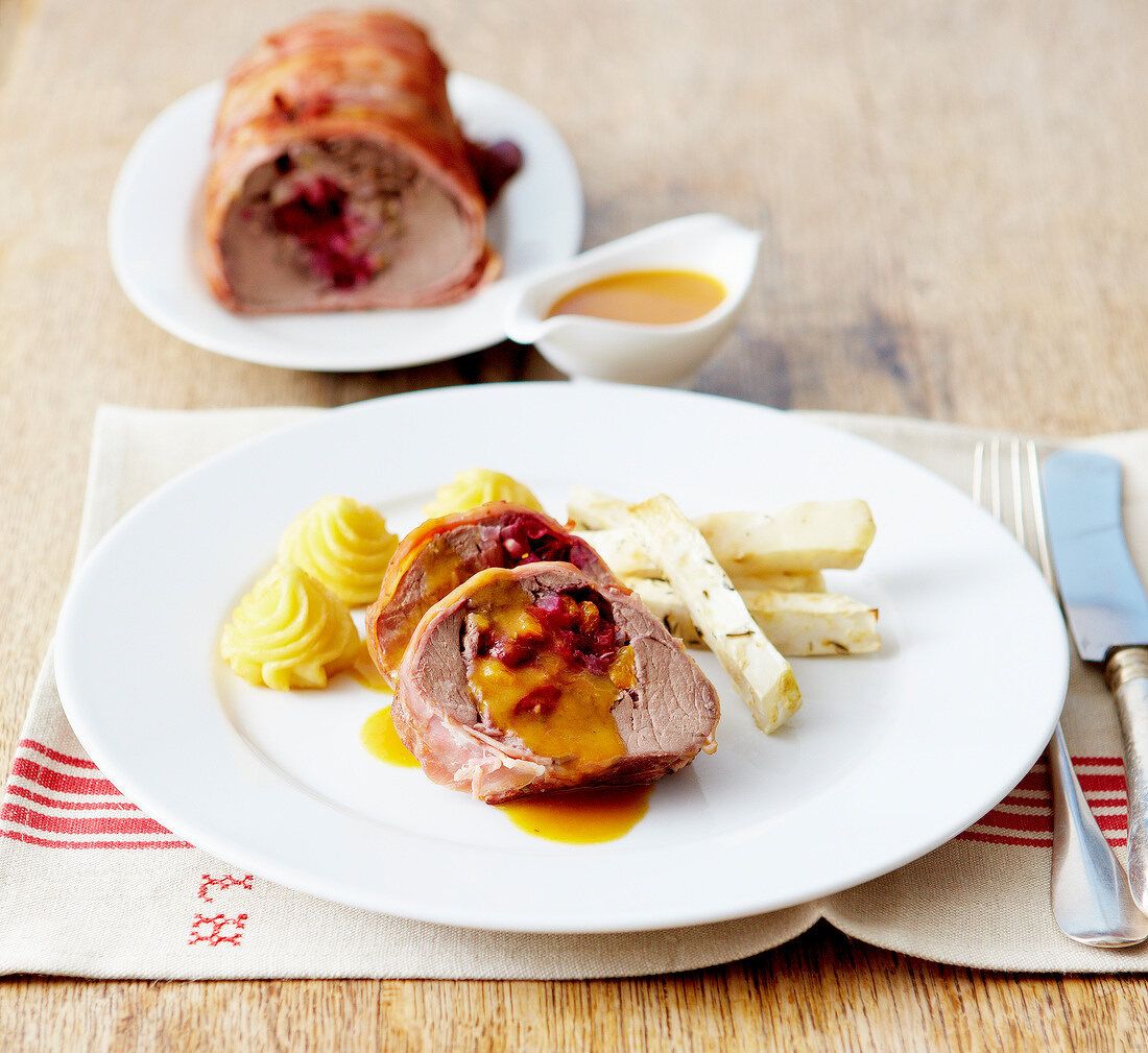 Roast pork stuffed with cranberries,apricot sauce,celeriac french fries and Duchesse potatoes