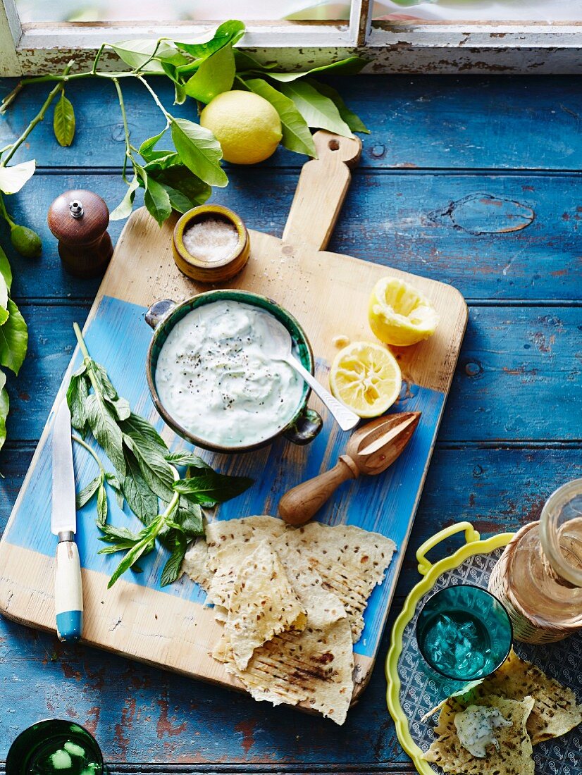 Preparing tzatziki with fresh herbs