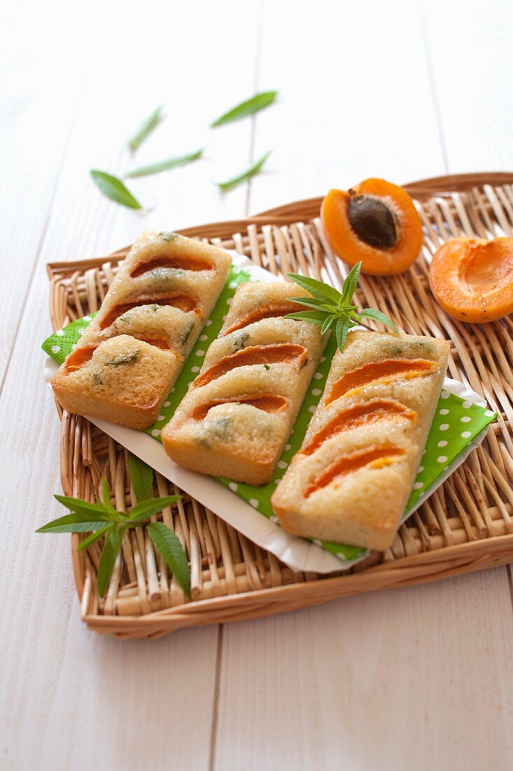 Financiers (French almond sponge cakes) with apricots, lemon balm and olive oil