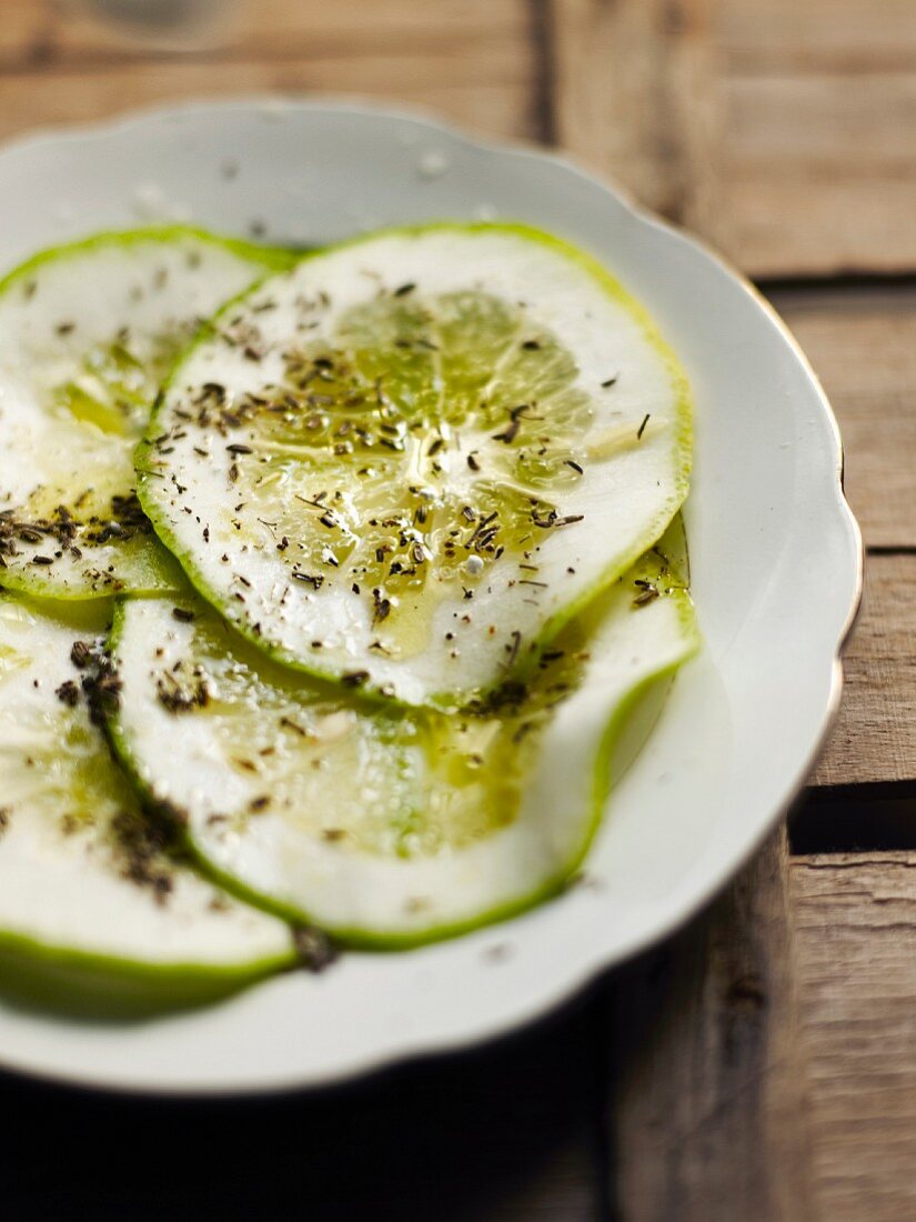 Thin slices of lime with olive oil and herbs