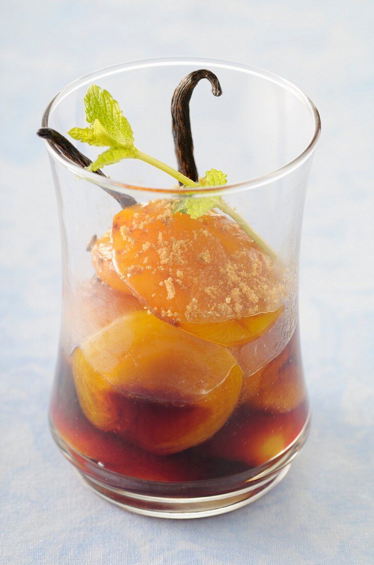 Poached apricots in vanilla-flavored blackcurrant syrup