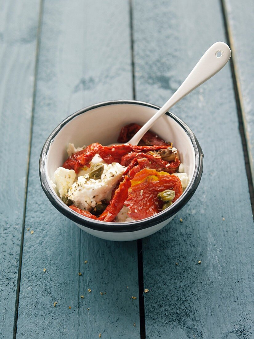 Füllung aus Fetakäse, eingelegten Tomaten und Kapern für Teigtaschen zubereiten