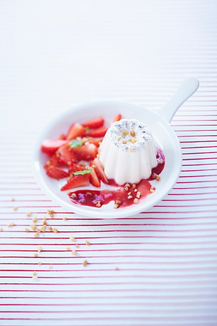 Cannelés-style vanilla panna cotta with strawberries in syrup