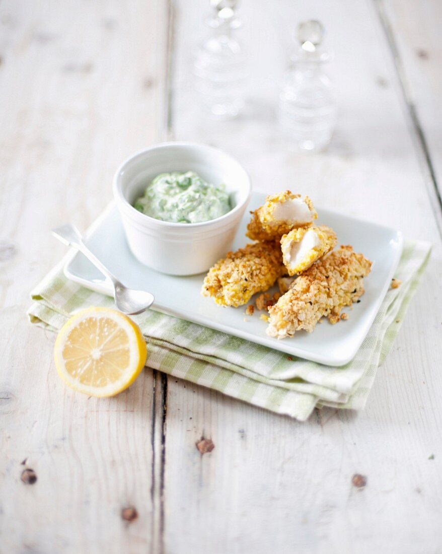 White fish fingers with green sauce
