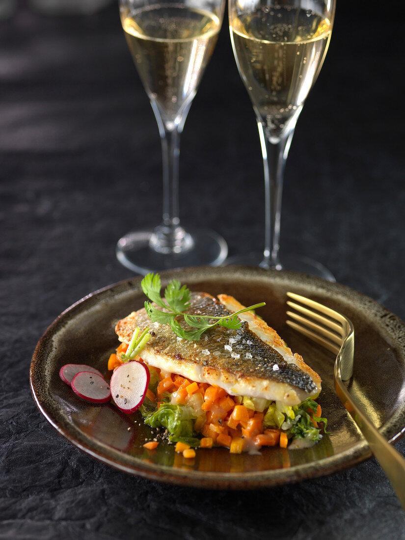 Roasted sea bream on a bed of diced vegetables in reduced Champagne sauce