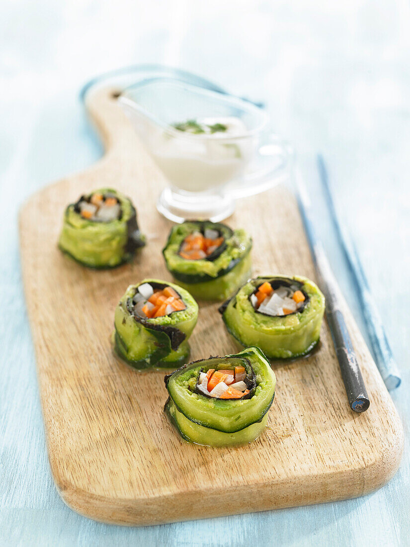 Cucumber sushi with guacamole and vegetables, yogurt sauce