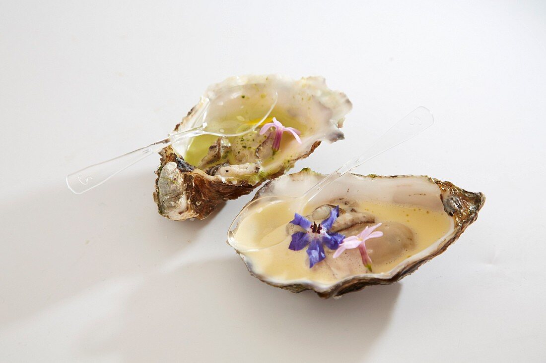 Oysters with white butter sauce and edible flowers