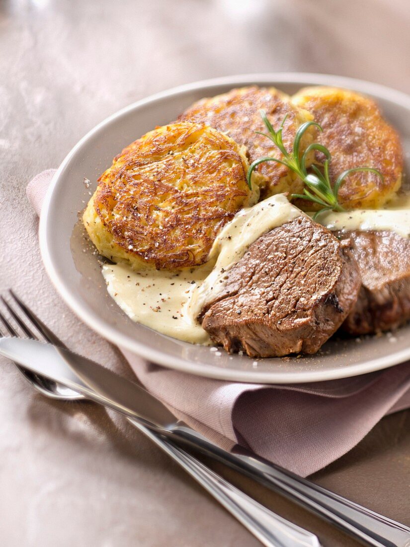 Thick beef fillet with mustard sauce and potato patties