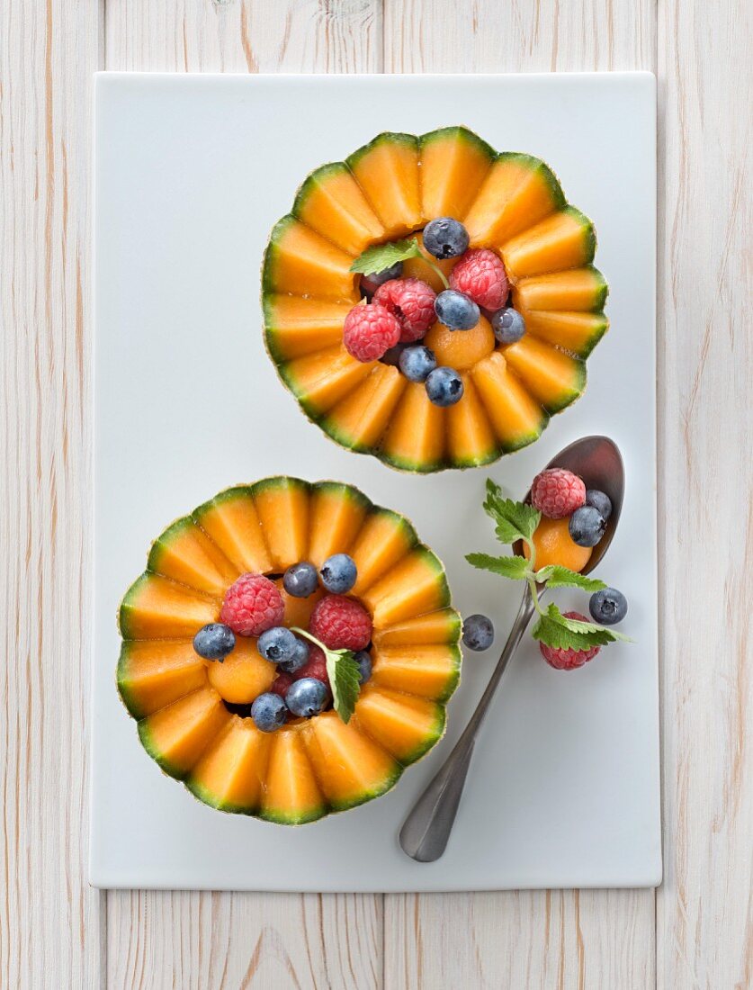 Melon garnished with raspberries and blackcurrants