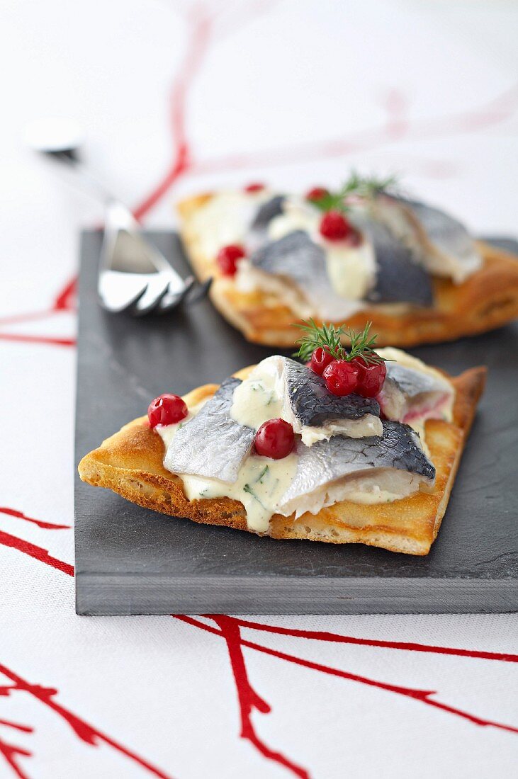 Toasted polar bread toped with rollmops and sweet and sour cream